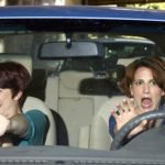 Two women panicking while driving on traffic