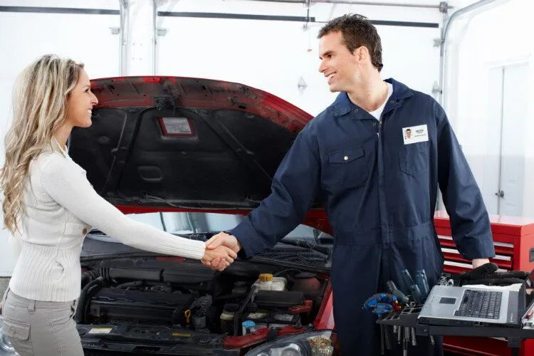 Woman-shaking-hands-with-mechanic Woman-shaking-hands-with-mechanic